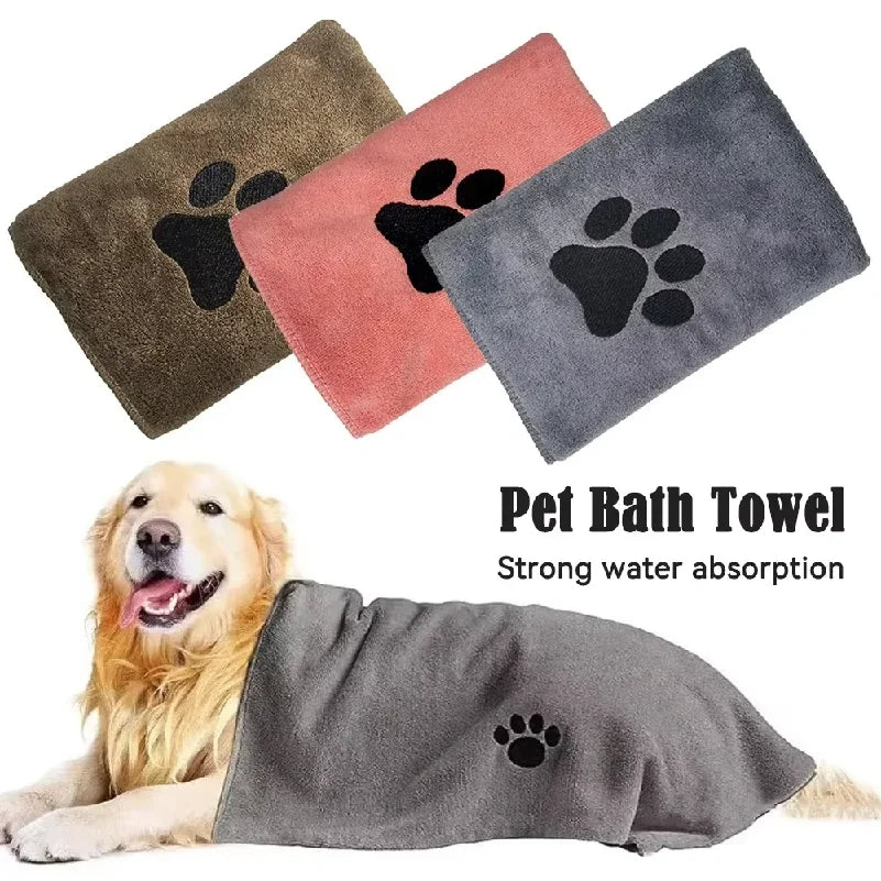 Pet bath towel with paw design, shown in brown, pink, and gray, with a dog using it.
